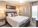 Cozy bedroom with a queen-size bed and farmhouse-style decor at 2650 58Th E Cir, Palmetto, FL 34221