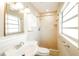 Bright bathroom with tiled shower, white vanity, and large mirror at 2268 Palmetto Dr, Clearwater, FL 33763