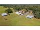 Aerial view of a property with main house, barns, and animal enclosures at 4911 W Sam Allen Rd, Plant City, FL 33565