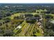 Aerial view of expansive property with home and outbuildings at 4911 W Sam Allen Rd, Plant City, FL 33565