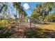 Fenced backyard with mature trees and storage shed at 4911 W Sam Allen Rd, Plant City, FL 33565
