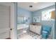 Vintage bathroom with blue vanity and toilet at 4911 W Sam Allen Rd, Plant City, FL 33565