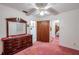 Bright bedroom with a dresser and pink carpet at 4911 W Sam Allen Rd, Plant City, FL 33565