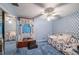Cozy bedroom featuring blue walls and carpeted floor at 4911 W Sam Allen Rd, Plant City, FL 33565