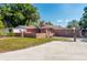 Brick ranch house with mature landscaping and large yard at 4911 W Sam Allen Rd, Plant City, FL 33565