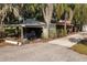 White garage with open carport and various items stored at 4911 W Sam Allen Rd, Plant City, FL 33565