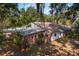 Brick house exterior with rusty metal roof and partial carport at 4911 W Sam Allen Rd, Plant City, FL 33565