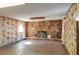 Spacious living room featuring a stone fireplace and brick flooring at 4911 W Sam Allen Rd, Plant City, FL 33565