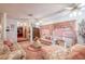 Spacious living room with floral couches and pink decor at 4911 W Sam Allen Rd, Plant City, FL 33565