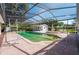 Enclosed pool area with a pool, fountain, and detached structure at 4911 W Sam Allen Rd, Plant City, FL 33565
