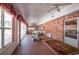 Spacious screened porch with brick flooring and access to the pool at 4911 W Sam Allen Rd, Plant City, FL 33565
