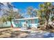 Charming light blue house with landscaped yard and palm trees at 1820 Douglas Ave, Clearwater, FL 33755
