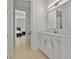 Clean bathroom with a white vanity and a view of a bedroom at 11449 Owasee Trails Pl, Riverview, FL 33569