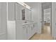 Modern bathroom with white vanity, quartz countertop, and spacious mirror at 11449 Owasee Trails Pl, Riverview, FL 33569