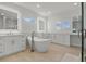 Luxurious bathroom with double vanity, soaking tub, and separate shower at 11449 Owasee Trails Pl, Riverview, FL 33569