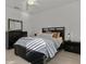 Bright bedroom featuring a striped comforter and a sleek black bed frame at 11449 Owasee Trails Pl, Riverview, FL 33569