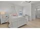 Charming bedroom with a white canopy bed and light wood floors at 11449 Owasee Trails Pl, Riverview, FL 33569