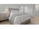 Spacious bedroom with a queen bed and light-colored wood floors at 11449 Owasee Trails Pl, Riverview, FL 33569