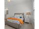 Cozy bedroom with a gray bed frame and orange accents at 11449 Owasee Trails Pl, Riverview, FL 33569