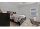 Cozy bedroom with a comfortable bed, a small work desk, and plenty of natural light at 11449 Owasee Trails Pl, Riverview, FL 33569