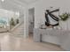 Light hardwood floors, contemporary console table, and open staircase at 11449 Owasee Trails Pl, Riverview, FL 33569