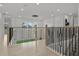 Stunning second-floor hallway with a modern railing and chandelier at 11449 Owasee Trails Pl, Riverview, FL 33569