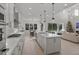 Spacious kitchen boasts an island, stainless steel appliances, and white cabinetry at 11449 Owasee Trails Pl, Riverview, FL 33569
