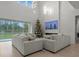 Spacious living room with high ceilings, large windows, and a cozy sectional sofa at 11449 Owasee Trails Pl, Riverview, FL 33569