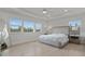 Spacious main bedroom with a king bed, hardwood floors, and large windows at 11449 Owasee Trails Pl, Riverview, FL 33569