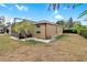 House exterior showcasing a screened patio and well-maintained lawn at 13113 Titleist Dr, Hudson, FL 34669