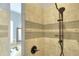 Bathroom featuring a shower with decorative tile and updated fixtures at 5352 Camberlea Ave, Zephyrhills, FL 33541