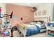 bedroom with a white bed frame and wall-mounted TV at 5352 Camberlea Ave, Zephyrhills, FL 33541