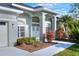 House entrance with gray double doors and lush landscaping at 5352 Camberlea Ave, Zephyrhills, FL 33541