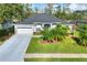 Single-story house with gray exterior, two-car garage, and palm trees at 5352 Camberlea Ave, Zephyrhills, FL 33541