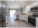 Modern kitchen with stainless steel appliances and light gray cabinets at 2504 58Th E Cir, Palmetto, FL 34221