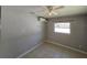 Cozy bedroom with a ceiling fan, tile floors, and modern air conditioning unit at 3967 Arkansas Ne Ave, St Petersburg, FL 33703