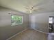 This bedroom features tile flooring, a ceiling fan, and access to an en-suite bathroom at 3967 Arkansas Ne Ave, St Petersburg, FL 33703