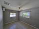 Bright bedroom features tile floors, a ceiling fan, and two windows offering natural light at 3967 Arkansas Ne Ave, St Petersburg, FL 33703