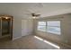 Well-lit bedroom with tile floors, a modern ceiling fan, and a large window for natural light at 3967 Arkansas Ne Ave, St Petersburg, FL 33703