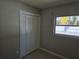 Simple bedroom featuring a window, bifold closet and tile flooring at 3967 Arkansas Ne Ave, St Petersburg, FL 33703