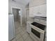 Functional kitchen featuring white appliances, cabinets, and modern countertops at 3967 Arkansas Ne Ave, St Petersburg, FL 33703