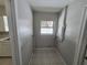 Bright laundry room featuring a window, tile flooring, and essential utility connections at 3967 Arkansas Ne Ave, St Petersburg, FL 33703