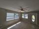 Open living room with ample natural light, tile flooring, and a contemporary ceiling fan at 3967 Arkansas Ne Ave, St Petersburg, FL 33703