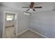 Living area featuring tile floors and neutral paint, complemented by a modern ceiling fan at 3967 Arkansas Ne Ave, St Petersburg, FL 33703