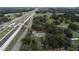 Expansive aerial view of a property with mature trees, a yellow home, and convenient highway access at 750 Charlie Taylor Rd, Plant City, FL 33566