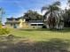Wide backyard with a well-maintained lawn, mature trees, and convenient back entrances at 750 Charlie Taylor Rd, Plant City, FL 33566