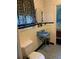 Cozy bathroom with blue fixtures, patterned wallpaper, and a classic design at 750 Charlie Taylor Rd, Plant City, FL 33566