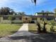 Charming two-story home featuring a bright facade, red shutters, and mature landscaping at 750 Charlie Taylor Rd, Plant City, FL 33566