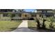 Charming two-story home featuring a bright facade, red shutters, and mature landscaping at 750 Charlie Taylor Rd, Plant City, FL 33566