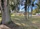 A quaint two-story home with a big front yard and mature palms at 750 Charlie Taylor Rd, Plant City, FL 33566